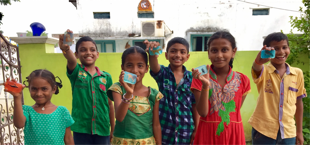 Kids holding FOREFRONT provided soap