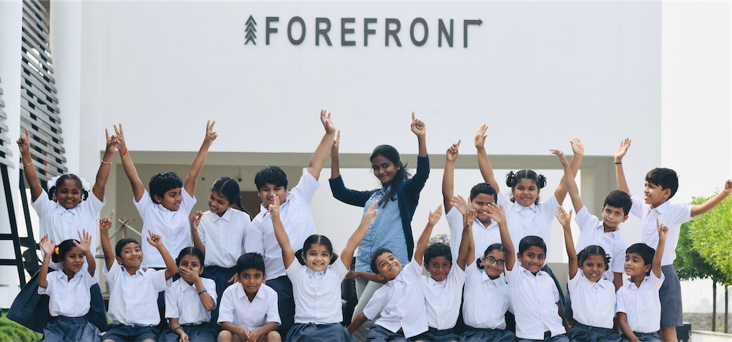 Teacher and students pointing up at FOREFRONT School
