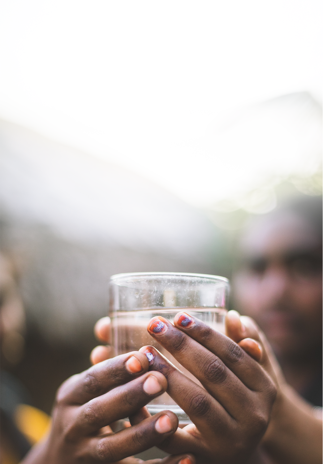 Clean water cup held by two hands